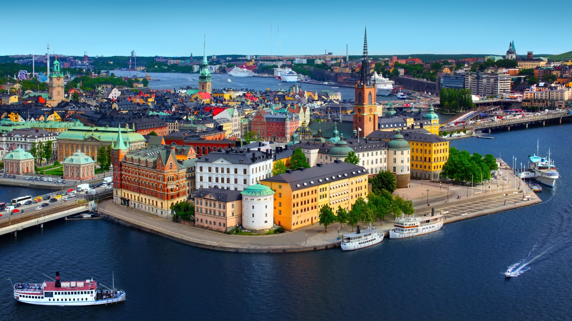 The image shows a panoramic view of Stockholm, Sweden, featuring colorful buildings, waterways, and boats. The skyline includes historical architecture and modern structures, with lush greenery and a vibrant atmosphere.