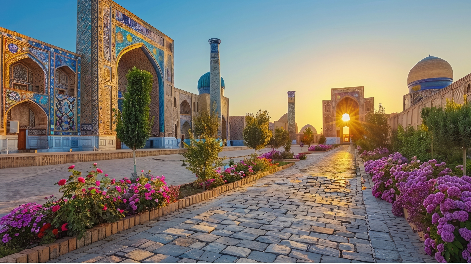 The image depicts the ancient city of Samarkand in Uzbekistan, showcasing its stunning architecture and vibrant flowers. It features intricate tile work on buildings, a cobblestone path, and a beautiful sunset illuminating the scene, highlighting its status as a UNESCO World Heritage Site.